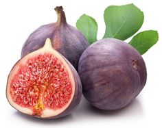 figs with leaves on white background, one cut in half and the other whole