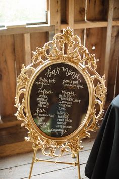 a gold frame with a wedding seating chart on the front, and an instagramtion board in the back