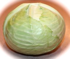 a head of cabbage sitting on top of a table