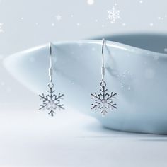 A pair of dainty snowflake dangle drop earrings, made of solid 925 sterling silver and cubic zirconia. Elegant snowflake design, light weight and comfortable to wear. A perfect gift for your love one in Christmas and holiday season. Jewelry Care: See more information about how to care for your jewelry here. Shipping Policy: Orders will be shipped within 1-3 business days. Economy shipping will take 7-14 days to arrive and standard shipping is 1- 4 days for U.S. orders. International shipping tim Elegant Snowflake Earrings For Winter, Silver Snowflake Cubic Zirconia Earrings, Sterling Silver Snowflake Earrings, Elegant Snowflake, Dazzling Earrings, Snowflake Earrings, Winter Snowflakes, Wedding Christmas, Snowflake Designs