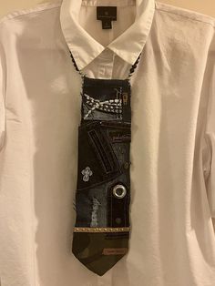 a tie made out of jeans hanging on a white shirt