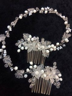 a close up of a hair comb with flowers and pearls on the headpieces