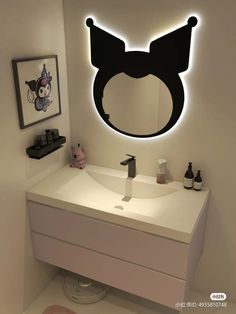 a bathroom with a sink, mirror and lights on the wall above it is decorated in black and white