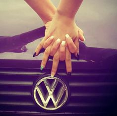 a woman's hands on the hood of a car