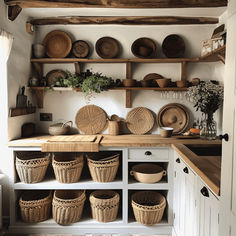 a kitchen with baskets and bowls on the shelves