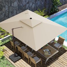 an overhead view of a patio table and umbrella next to a swimming pool with a stone wall in the background