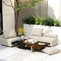 a living room filled with furniture next to a planter and potted tree in front of a building