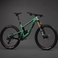 a green and black mountain bike against a gray background