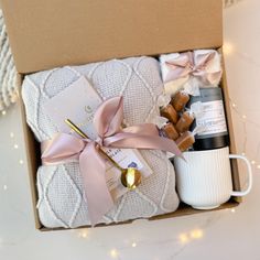 a gift box with coffee, marshmallows, and other items in it