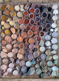 many different colored powders are in small bowls