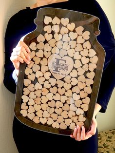 a woman holding up a tray with wood slices on it