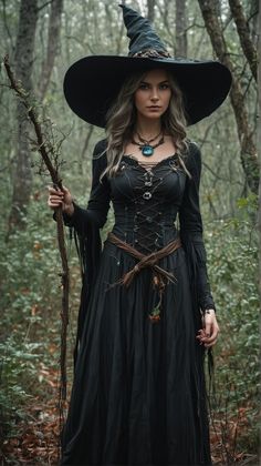 a woman dressed as a witch in the woods