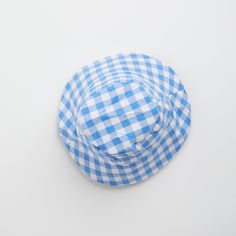 Introducing the Gingham Sunhat! Keep your little one looking stylish and shaded with this fun and fashionable cornflower blue baby sun hat, complete with checkered gingham print that your baby will love. Perfect for a day at the beach or a stylish stroll in the park. Shade in style! Fits ages 6 - 12 months Summer Plaid Bucket Hat, Casual Gingham Hats For Summer, Summer Gingham Hat With Curved Brim, Plaid Curved Brim Hat For Beach, Plaid Curved Brim Hat For The Beach, Summer Plaid Brimmed Hat, Plaid Hats For Summer Beach, Plaid Summer Beach Hat, Adjustable Plaid Hats For Beach