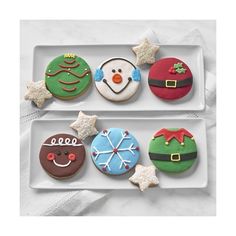 an image of christmas cookies in the shape of santa's hats and snowmen