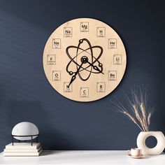 a wooden clock with an atomic symbol on it