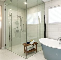 a bath room with a stand up shower and a tub