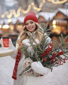 a woman holding a tray with christmas decorations