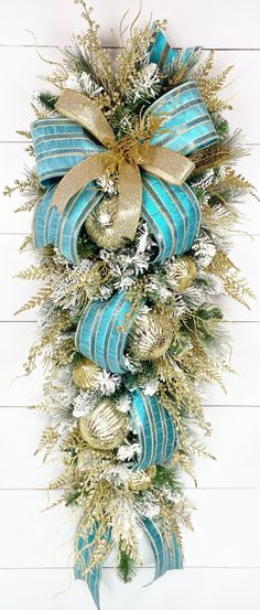 a blue and gold christmas wreath hanging on the wall