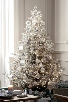 a white christmas tree with silver ornaments