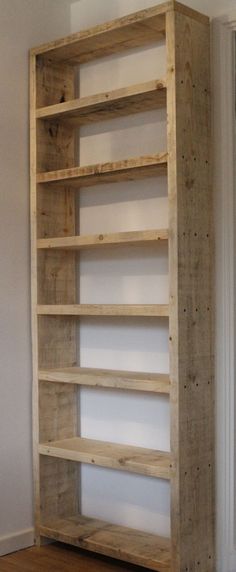 an empty wooden shelf in the corner of a room