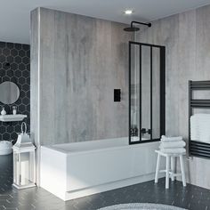 a bathroom with black and white tiles on the walls, floor, and bathtub