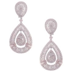 These modern pear baguette earrings are crafted in 18-karat white gold, weighing approximately 11.82 total carats of SI-V Quality white diamond. French Clip backing. Beautiful rose gold accent. Our Ballroom Collection feature earrings for those with bold/classy aesthetics and elegant tastes. 304 Round Diamonds = 5.87 ct 182 Baguette Diamonds = 5.95 ct Classy Aesthetics, Baguette Earrings, Pear Earrings, French Clip, Diamond Dangle Earrings, Baguette Diamonds, Circle Diamond, White Gold Earrings, Pearl Earrings Dangle