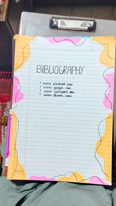 a piece of paper on top of a binder with writing underneath it that says bibliography