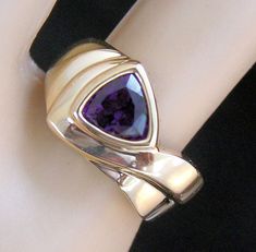 Exquisite 14 karat yellow gold ring with one trillion cut amethyst (approximately 1 carat). The ring measures approximately 11 millimeters across the top and 3.5 millimeters at the shank. It is approximately a size 5.5, and can be re-sized to fit by your local jeweler. It weighs approximately 6.16 grams and is stamped 14K. Excellent, like-new condition. We are listing several pieces of estate jewelry, along with other items fresh from fine North Carolina estates. We are happy to combine shipping 14k Yellow Gold Amethyst Ring With Polished Finish, 14k Yellow Gold Polished Amethyst Ring, Wedding Amethyst Ring In Polished Yellow Gold, Wedding Amethyst Ring With Polished Yellow Gold Finish, Wedding Yellow Gold Amethyst Ring With Polished Finish, Modern 14k Gold Amethyst Wedding Ring, Trillion Cut Polished Jewelry For Anniversary, Trillion Cut Jewelry With Polished Finish For Anniversary, Anniversary Amethyst Ring In Yellow Gold And Sterling Silver