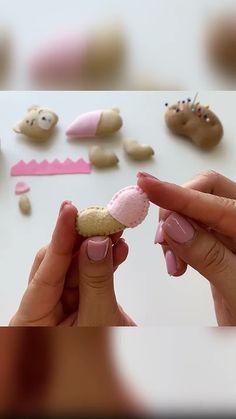 a woman is holding a cookie in front of other cookies and candies on a table