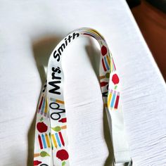 Add a personalized touch to your school day with our adorable custom lanyard, featuring a fun school supply theme and your name printed on both sides! Measuring 7/8” in width and 36” in total length (including hardware), this lanyard is perfect for holding your school ID or keys. Made from soft polyester fabric, it offers comfort for all-day wear, and includes a plastic breakaway closure for safety. The lobster clasp securely attaches to your keys or badge, keeping them organized and easy to acc Personalized Multicolor Badge Holders For School, Personalized Fun School Craft Supplies, White Adjustable Fun Lanyards, Personalized Multicolor Lanyards For Teacher Appreciation, Personalized Adjustable Lanyards For School, Personalized White Lanyards For School, Customizable Multicolor Badge Holders For School, Personalized White Lanyards For Everyday Use, Customizable Adjustable White Lanyards