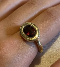 This simple 9 ct yellow gold ring featuring a deep red garnet is rustic and elemental . The textured gold makes this unique ring both organic and luxe Pomegranate Ring, Garnet And Diamond Ring, Xmas 2024, Red Stone Ring, Talisman Necklace, Solitaire Rings, Garnet And Gold, Etsy Gold Ring, Jewelry Lookbook