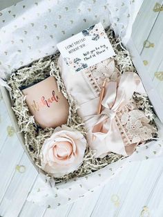 an open box containing a pink coffee mug and two matching bows, with a note on it