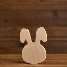 a wooden toy rabbit sitting on top of a table