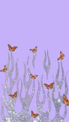 some butterflies are flying in the air over fire and ice flakes on a purple background