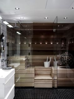 a bathroom with glass walls and tiled flooring