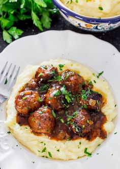 a plate with mashed potatoes and meatballs on it