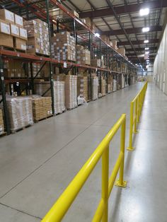 a warehouse filled with lots of boxes and pallets on the shelves next to each other