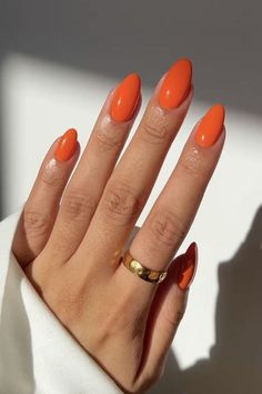 Summer Nail Inspo Almond One Color, September Nail Ideas Almond Shape, Peach Acrylic Nails Almond, Bold Nail Colors Summer, Gel Nails Orange Summer Colors, Round Vacation Nails, Orange Nail Colors Summer, Orange Oval Acrylic Nails, Summer Nails Olive Skin