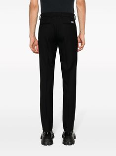 slim-cut wool trousers from Versace featuring black, virgin wool, logo patch to the rear, belt loops, hook and zip fly fastening, side pouch pockets, two rear welt pockets and slim cut. Size Info IT Color Detail Black Made In Italy Material Exterior: 100% virgin wool Lining: Cupro 100%, Cotton 100% Season One Fall-Winter Season Two Fall-Winter Product trousers Brand Versace Size And Fit This piece fits true to size. We recommend you get your regular sizeModel is 1,84m / 6ft 1in wearing size 48 ( Trench Dress, Latest Fashion Design, Trench Jacket, Crossbody Tote Bag, Cape Coat, Wool Trousers, Blazer With Jeans, Pant Shirt, Welt Pockets