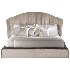 a large bed with pillows and blankets on it's headboard, against a white background