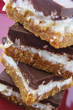 three pieces of chocolate and coconut bars stacked on top of each other