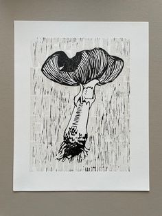 a black and white drawing of a mushroom on a sheet of paper with water droplets