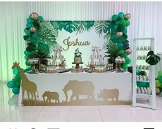 an elephant and giraffe themed dessert table