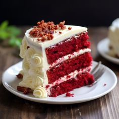 a slice of red velvet cake with white frosting and chopped pecans on top