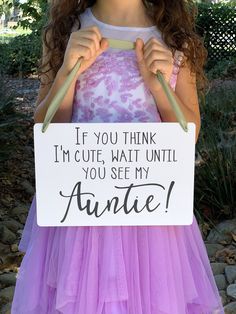 "This beautiful \"If you think I'm cute, wait until you see my Auntie!\" sign is perfect for your little ring bearer or flower girl to carry down the aisle. It is sure to bring a sweet smile to your wedding guests.   This sign is approximately 8\"H x 12\"W.  It is a gorgeous printed sign on a very pretty thin piece of white plastic with a foam core center and about 1/8\" thick. Think foam board but the front and back are a very thin white layer of plastic instead of paper. This makes it extremely light weight and much sturdier than paper. It is perfect for small children to handle and carry. It comes with a long Satin Ribbon, in your color choice and can be adjusted to fit your little ring bearer to carry or wear over their neck. You also have the option to not have any holes/ribbon on the Ring Bearer Sign, Ring Bearer Signs, Flower Girl Signs, Ring Bearer Flower Girl, Wedding Ring Bearer, Rose Gold Party, Ceremony Signs, Girl Sign, Bridal Shower Welcome Sign