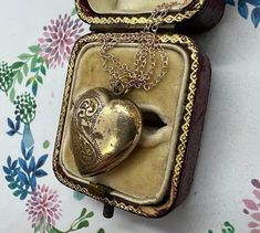 An attractive vintage rolled gold heart locket on a modern gold plated chain. The locket is rolled gold and stamped to the back of the locket as 'Rolled Gold'. The front of the locket has lovely engraved detail - with a scrolling/floral pattern, eye catching and allows the locket to catch the light - very pretty indeed. The locket still has very good gold coverage however there is light rubbing in places - adding to the vintage looks and feel. The locket is a nice size, measuring approx. 2.1cm long (not including the jump hoop) and 1.7cm at its widest part. The locket has been hung on a modern gold plated chain marked 925 for silver - the chain has a rosey hue. The chain is 16 inches long and has a spring ring closure. The locket and chain weigh 3.7g in total. The locket opens and closes v Antique Locket Necklace For Anniversary Gift, Gold Etched Locket Necklace, Vintage Yellow Gold Locket Necklace For Anniversary, Vintage Locket Necklace As Keepsake, Vintage Locket Necklace For Anniversary, Victorian Engraved Necklace For Anniversary, Antique Pendant Locket Necklace For Anniversary, Etched Gold Pendant Locket Necklace, Vintage Necklace For Anniversary Gift