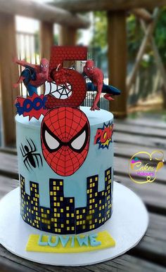 a spiderman themed birthday cake on a table