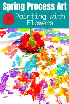 a flower sitting on top of a table covered in paint with the words spring process art painting