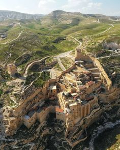 an aerial view of a castle in the mountains