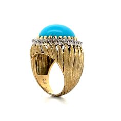 Make a statement with this stunning vintage cocktail ring! Crafted in 14 karat yellow gold, this Mid-Century piece features a richly textured band and an oval cabochon cut turquoise as the centerpiece. At 16.87 carats, the cabochon cut turquoise exudes a captivating blue hue, making it a standout in any crowd. Surrounding the turquoise are thirty-two (32) accenting natural diamonds, each measuring 1.8mm and weighing .025 carats, for a total accent stone weight of .80 carats. The diamonds add a t Vintage Cocktail Ring, Diamond Cocktail Ring, Diamond Cocktail Rings, Vintage Cocktail, Shop Engagement Rings, Vintage Turquoise, Vintage Beauty, Oval Cabochon, Cocktail Ring